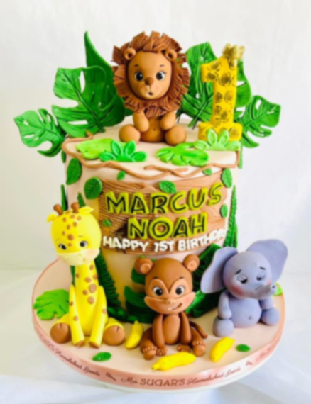 Safari themed 1-tier fondant cake with 3D edible lion, giraffe, monkey, and elephant figures and tropical leaves. Safari themed 1-tier fondant cake with 3D edible lion, giraffe, monkey, and elephant figures and tropical leaves.
