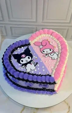 Sanrio-Inspired Heart Birthday Cake Heart-shaped cake with lavender and pink soft icing, featuring Kuromi and My Melody printouts and piped shell borders