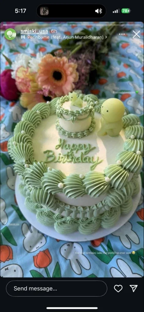 Smiski Birthday White 2-Tier Cake White 2-tier cake with smooth icing, Smiski birthday theme, green rosettes, and toy figures