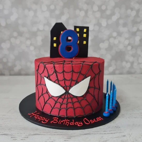 Spider Man Red Birthday Cake Red 1-tier soft icing birthday cake with black spider web piping, city skyline printout, and an age topper