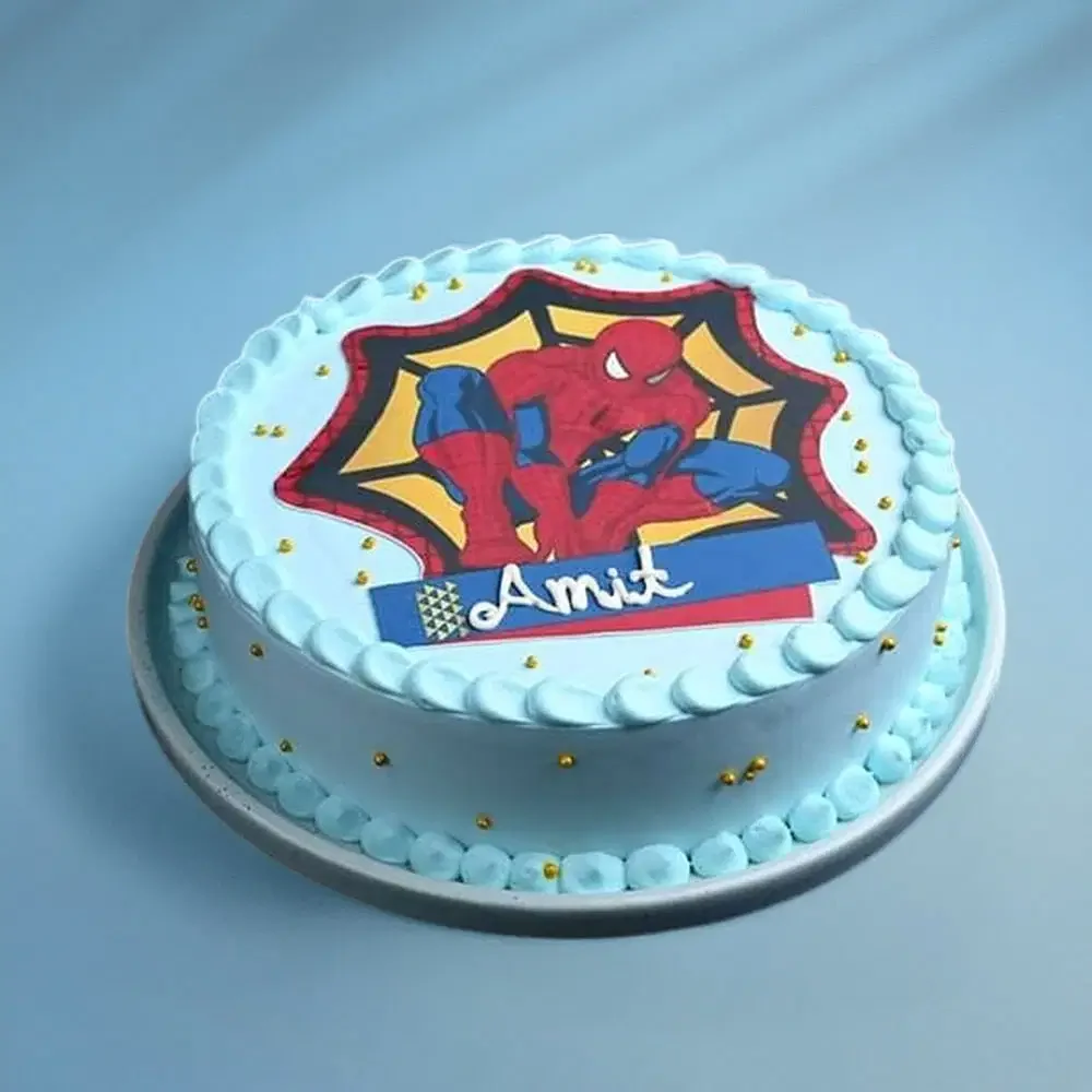 Spiderman-Inspired Sky Blue Birthday Cake Light blue 1-tier soft icing birthday cake with a Spiderman printout topper, gold dragees, and piped borders