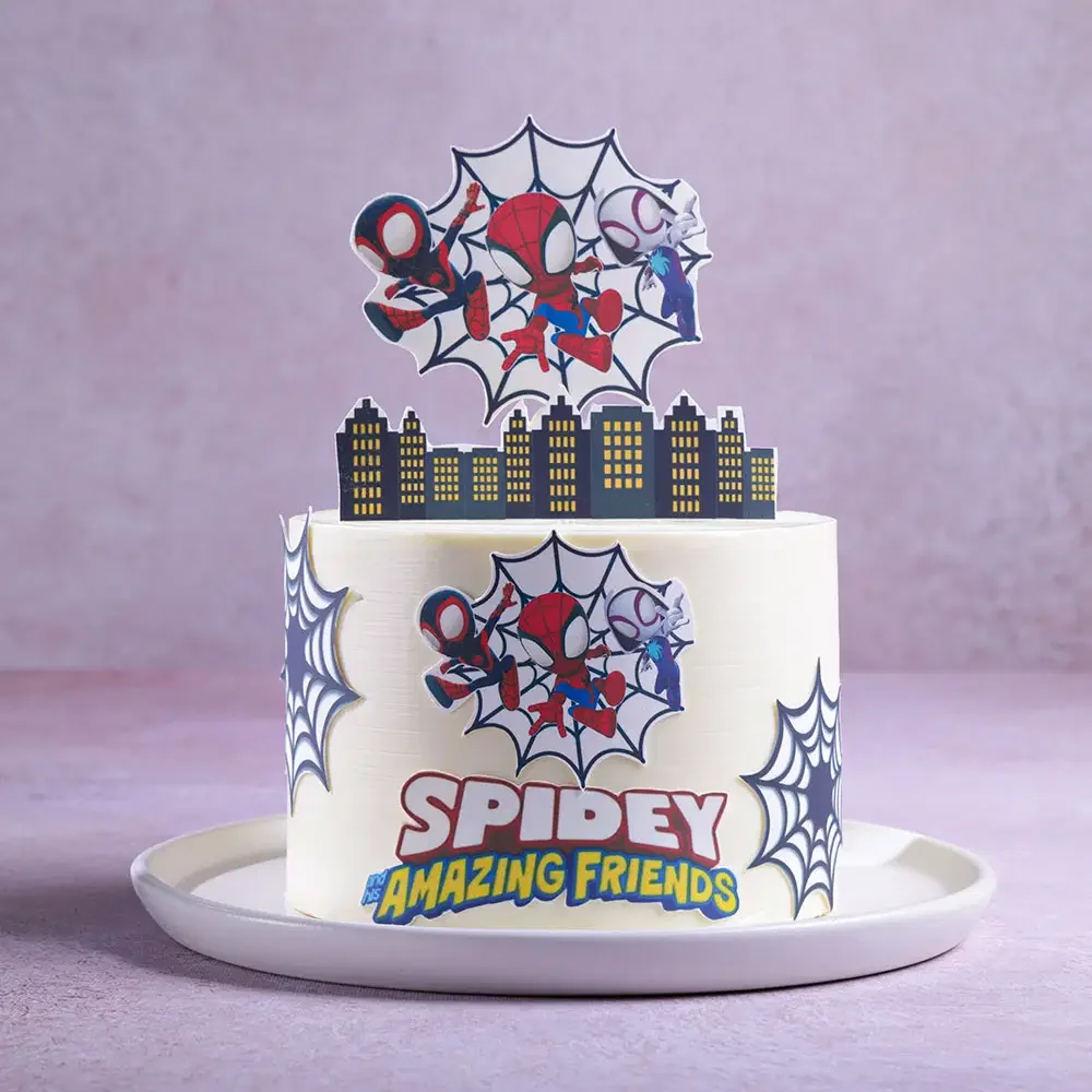 Spiderman-Inspired White Birthday Cake White 1-tier soft icing birthday cake with Spidey and His Amazing Friends character printouts and web decorations