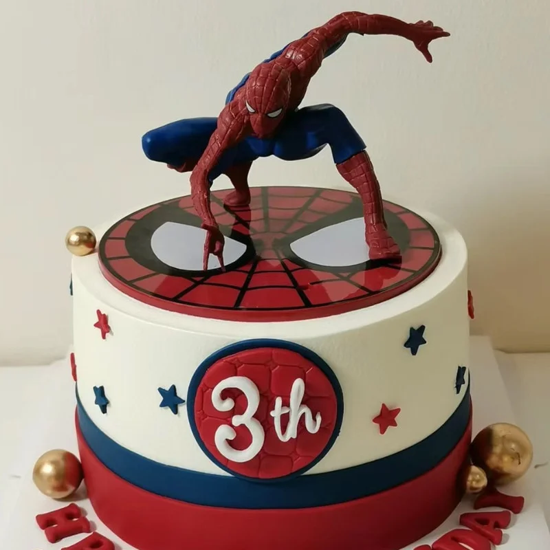 Spiderman-Inspired Birthday Cake White 1-tier birthday cake with smooth soft icing, a Spiderman action figure, mask topper, and blue and red stars