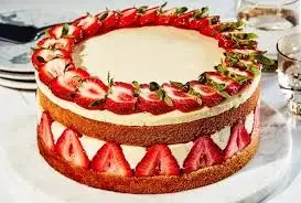 Naked strawberry cake with fresh strawberry slices on top and around the middle layer of cream. Naked strawberry cake with fresh strawberry slices on top and around the middle layer of cream.
