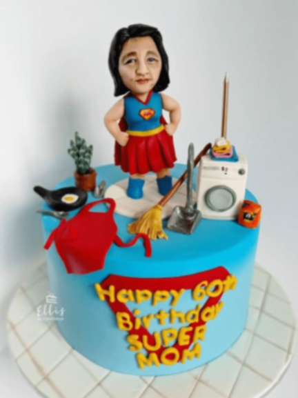 Light blue fondant cake for a 60th birthday featuring a custom 3D super mom figure and household cleaning tools. Light blue fondant cake for a 60th birthday featuring a custom 3D super mom figure and household cleaning tools.