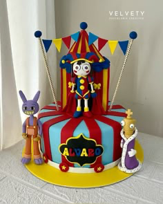 The Amazing Digital Circus themed fondant cake featuring Pomni, Jax, and Kinger figures with a circus tent backdrop. The Amazing Digital Circus themed fondant cake featuring Pomni, Jax, and Kinger figures with a circus tent backdrop.