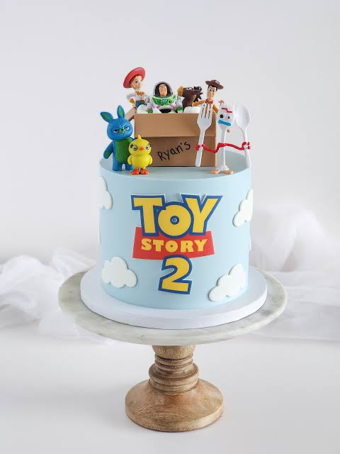 Toy Story-Inspired Sky Blue Cake Sky blue 1 tier cake with smooth soft icing, Toy Story theme, and plastic character figurines with fondant clouds