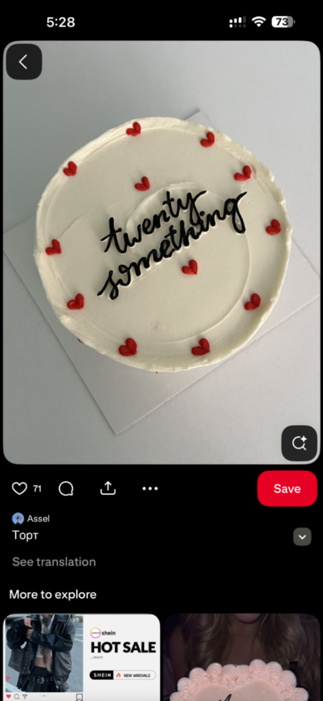 White minimalist bento-style cake with red icing hearts and black cursive text reading twenty something. White minimalist bento-style cake with red icing hearts and black cursive text reading twenty something.