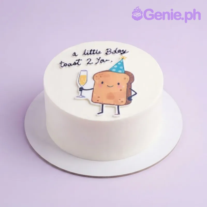 White bento cake with a printed toast character wearing a party hat and holding a champagne glass on top White bento cake with a printed toast character wearing a party hat and holding a champagne glass on top