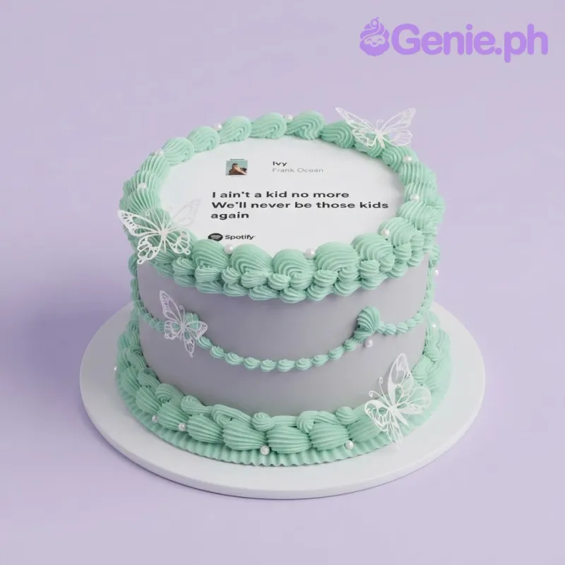 White 1-tier cake with mint green piped borders, white pearl accents, and a Spotify song interface edible photo top with butterfly cutouts White 1-tier cake with mint green piped borders, white pearl accents, and a Spotify song interface edible photo top with butterfly cutouts