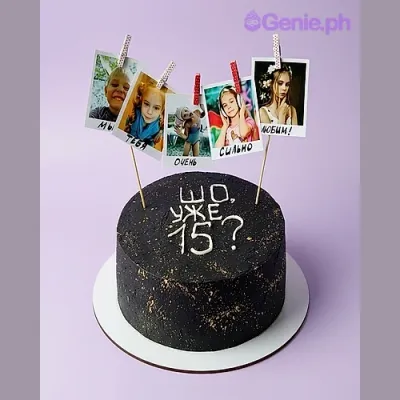 Black 1-tier birthday cake with five photo printouts on sticks and white piped text Black 1-tier birthday cake with five photo printouts on sticks and white piped text