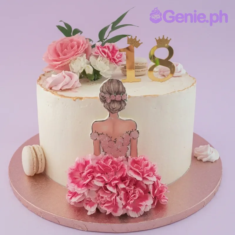 A white and pink 1-tier 18th birthday cake, featuring a girl in a floral dress, gold '18' toppers, pink roses, macarons. A white and pink 1-tier 18th birthday cake, featuring a girl in a floral dress, gold '18' toppers, pink roses, macarons.
