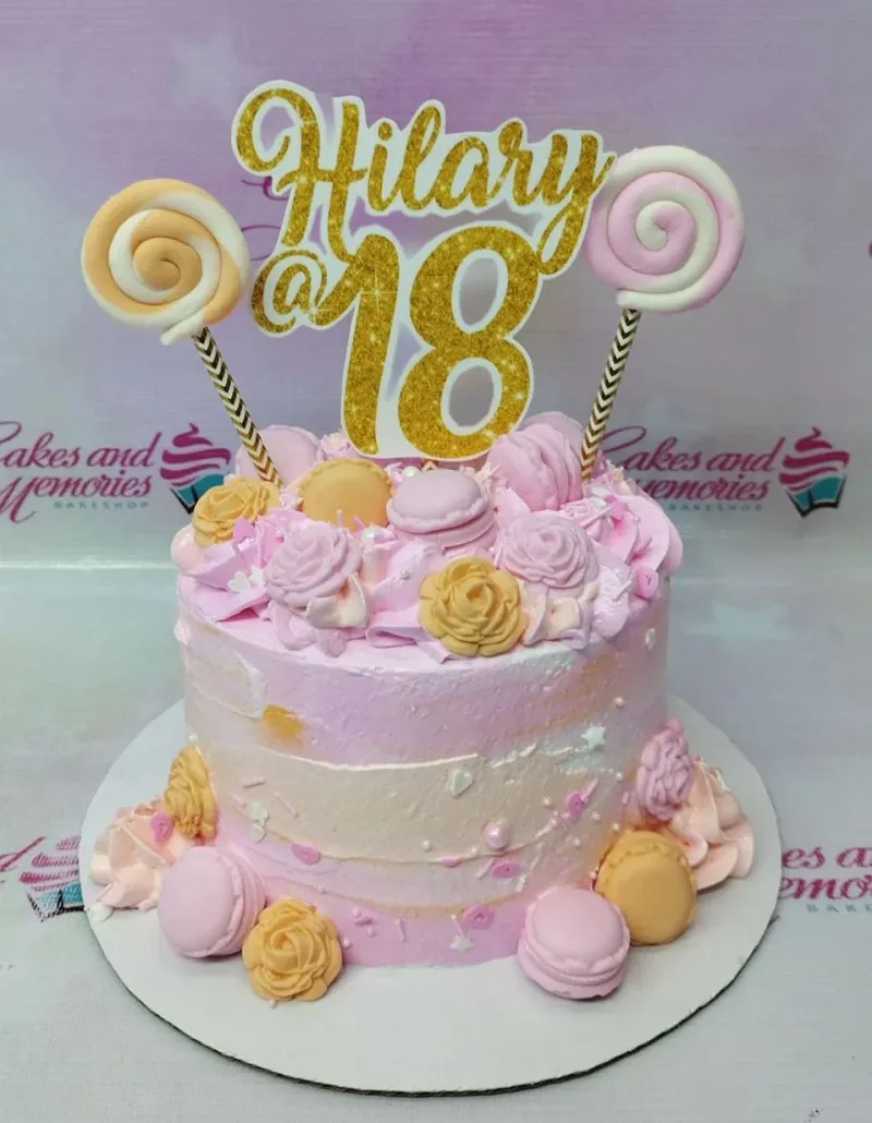 Pink and peach 18th birthday cake with gold glitter topper, macarons, and icing rosettes. Pink and peach 18th birthday cake with gold glitter topper, macarons, and icing rosettes.