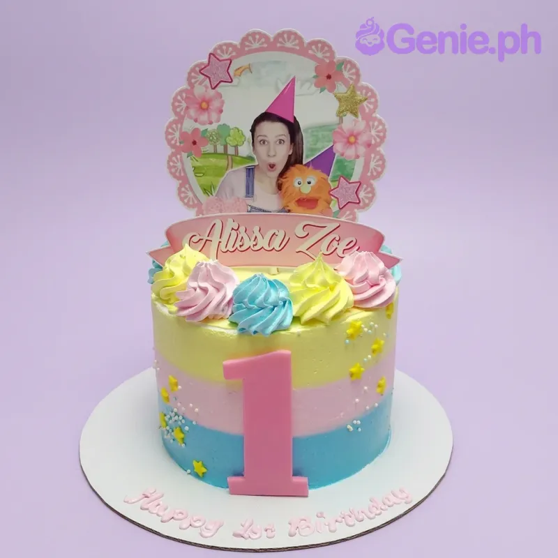 A colorful 1 Tier 1st Birthday Photo cake featuring a custom photo, name banner, number 1, stripes, and icing swirls. A colorful 1 Tier 1st Birthday Photo cake featuring a custom photo, name banner, number 1, stripes, and icing swirls.