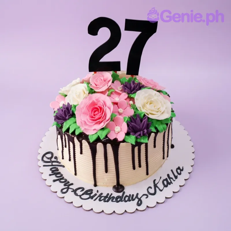 A white 1-tier birthday cake themed for a 27th birthday, featuring a black number 27 topper, colorful gumpaste flowers, and chocolate drip. A white 1-tier birthday cake themed for a 27th birthday, featuring a black number 27 topper, colorful gumpaste flowers, and chocolate drip.