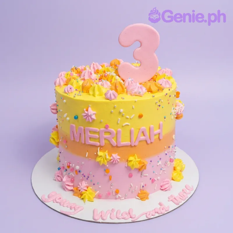 A vibrant yellow and pink gradient birthday cake with a large pink number 3 topper, colorful icing swirls, and sprinkles. A vibrant yellow and pink gradient birthday cake with a large pink number 3 topper, colorful icing swirls, and sprinkles.