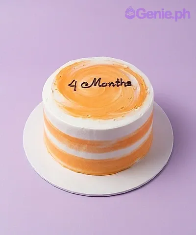 4 months orange cake design — 1 layer soft icing cake in orange and white — with silver dragees, and custom "4 Months" message 4 months orange cake design — 1 layer soft icing cake in orange and white — with silver dragees, and custom "4 Months" message