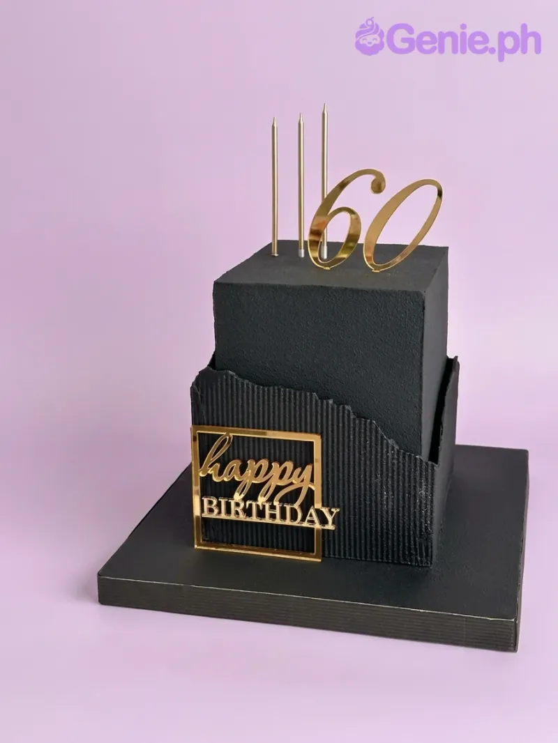 Black 2-tier square 60th cake with gold '60' topper, 'Happy Birthday' plaque, and textured base. Black 2-tier square 60th cake with gold '60' topper, 'Happy Birthday' plaque, and textured base.