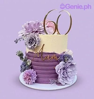 Elegant purple and cream textured cake with large lavender silk flowers and a gold 60 topper. Elegant purple and cream textured cake with large lavender silk flowers and a gold 60 topper.
