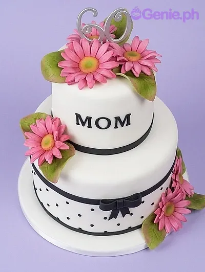 Elegant 2-tier white fondant cake for a 60th birthday with pink gerbera daisies, black ribbon accents, and a black 60 topper. Elegant 2-tier white fondant cake for a 60th birthday with pink gerbera daisies, black ribbon accents, and a black 60 topper.