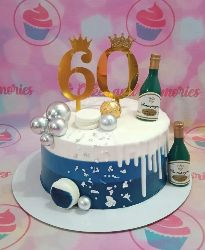 A blue and white 1 Tier cake themed around 60th Birthday, featuring gold '60' toppers, champagne bottles, and silver spheres. A blue and white 1 Tier cake themed around 60th Birthday, featuring gold '60' toppers, champagne bottles, and silver spheres.