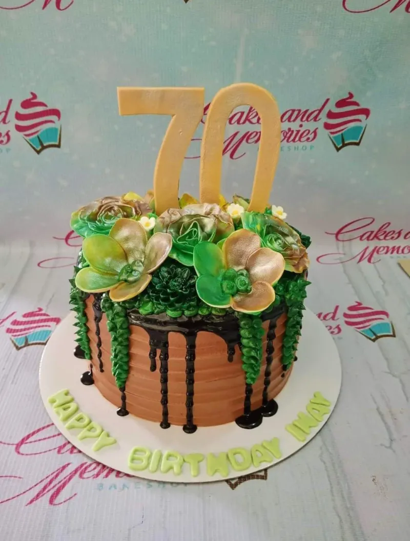 A brown and green 1-tier cake themed for a 70th Birthday, featuring a gold '70' topper, green succulent icing, chocolate drip, and gold and green flowers. A brown and green 1-tier cake themed for a 70th Birthday, featuring a gold '70' topper, green succulent icing, chocolate drip, and gold and green flowers.