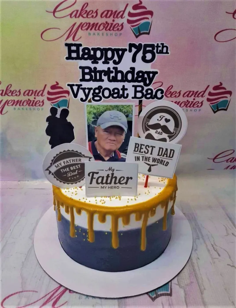 Navy blue and white gradient cake for a 75th birthday with a photo topper and gold drip accents. Navy blue and white gradient cake for a 75th birthday with a photo topper and gold drip accents.
