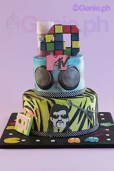 A multi-colored 80s retro 2-tier fondant cake, with MTV logo and boombox. A multi-colored 80s retro 2-tier fondant cake, with MTV logo and boombox.