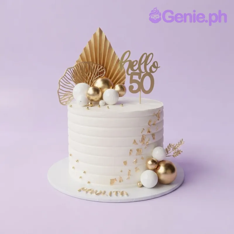 White 1-tier cake with smooth icing, gold and white sphere toppers, a gold hello 50 cardstock topper, and a dried palm leaf accent White 1-tier cake with smooth icing, gold and white sphere toppers, a gold hello 50 cardstock topper, and a dried palm leaf accent
