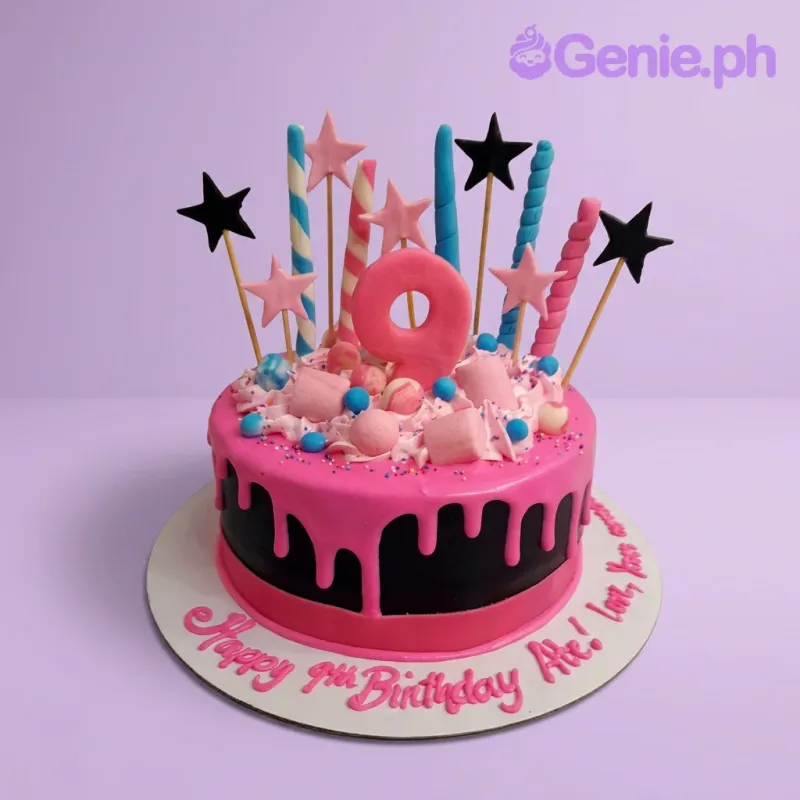 A black and pink 9th birthday cake, featuring a number 9, spiral toppers, drip, marshmallows, and stars. A black and pink 9th birthday cake, featuring a number 9, spiral toppers, drip, marshmallows, and stars.