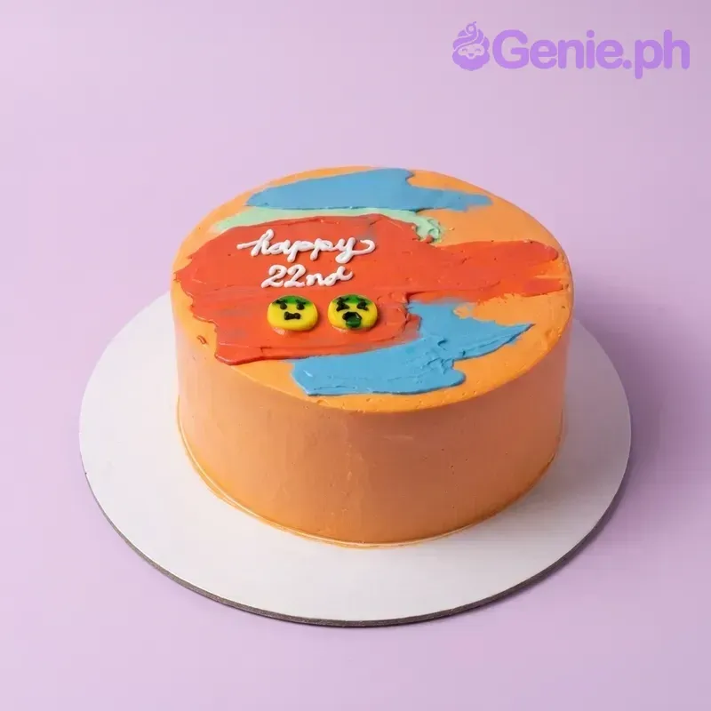 An orange 1-tier cake with artistic blue and red palette knife icing strokes, two yellow emoji faces, and 'Happy 22nd' text. An orange 1-tier cake with artistic blue and red palette knife icing strokes, two yellow emoji faces, and 'Happy 22nd' text.