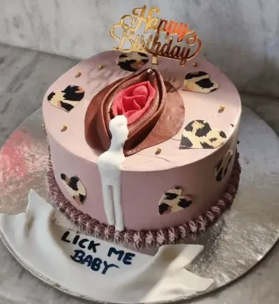 Light pink soft icing single tier cake with a sculpted fondant vulva top art, leopard hearts, and a gold acrylic topper Light pink soft icing single tier cake with a sculpted fondant vulva top art, leopard hearts, and a gold acrylic topper