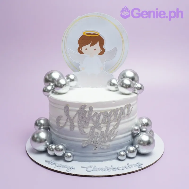 A white and gray gradient 1-tier cake themed around Angel Christening, featuring an angel printout topper, silver decorative spheres, and text. A white and gray gradient 1-tier cake themed around Angel Christening, featuring an angel printout topper, silver decorative spheres, and text.