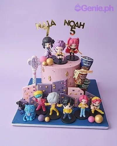 Pink and purple anime character cake with multiple figurines, city skyline gumpaste panels, and gold accents. Pink and purple anime character cake with multiple figurines, city skyline gumpaste panels, and gold accents.