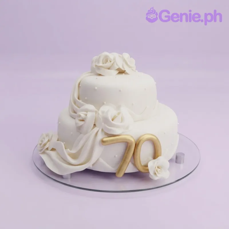 White 2-tier fondant anniversary cake with a fondant drape, white roses, and gold number 70 topper White 2-tier fondant anniversary cake with a fondant drape, white roses, and gold number 70 topper