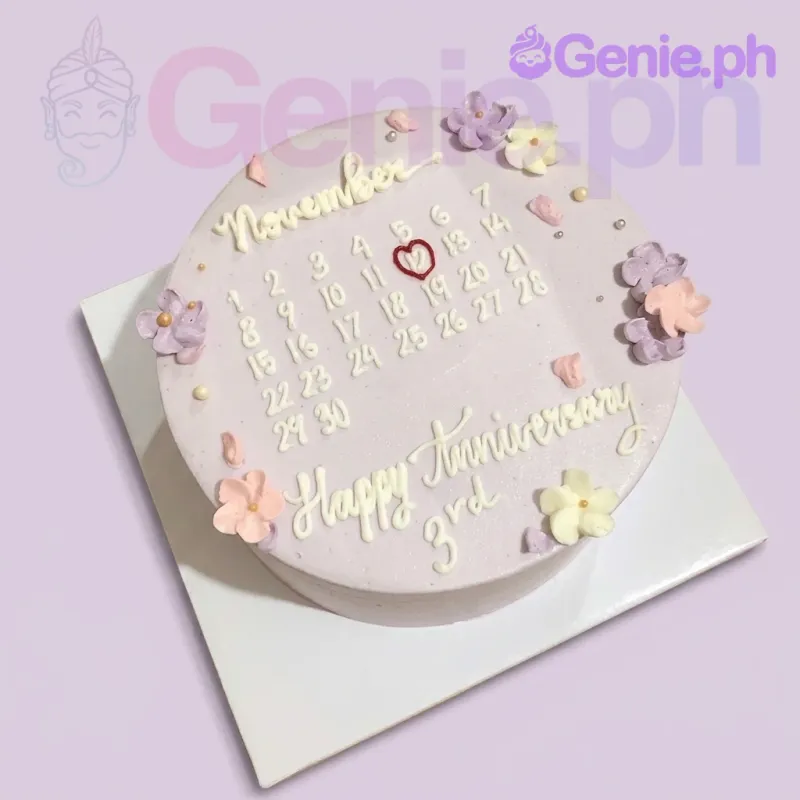 A lavender 1-tier cake themed around an Anniversary Calendar, featuring a hand-piped calendar design and icing flowers. A lavender 1-tier cake themed around an Anniversary Calendar, featuring a hand-piped calendar design and icing flowers.