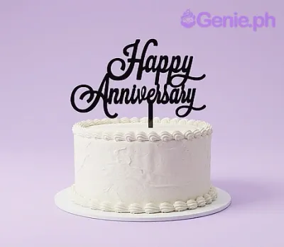 A white 1-tier Anniversary Minimalist cake, featuring a large black 'Happy Anniversary' cardstock topper and white icing border. A white 1-tier Anniversary Minimalist cake, featuring a large black 'Happy Anniversary' cardstock topper and white icing border.