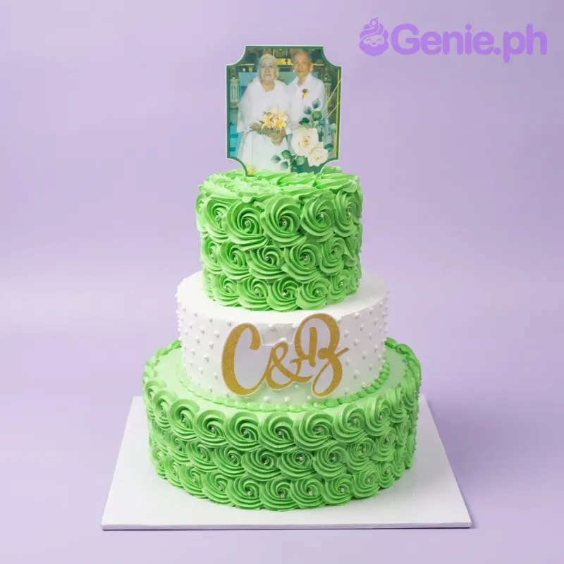 Green and white three-tier Anniversary cake, featuring an elderly couple photo and green rosettes with silver dragees. Green and white three-tier Anniversary cake, featuring an elderly couple photo and green rosettes with silver dragees.