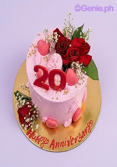 Pink anniversary cake with red roses, baby's breath, pink hearts, and a red number 20 topper on a gold base board. Pink anniversary cake with red roses, baby's breath, pink hearts, and a red number 20 topper on a gold base board.