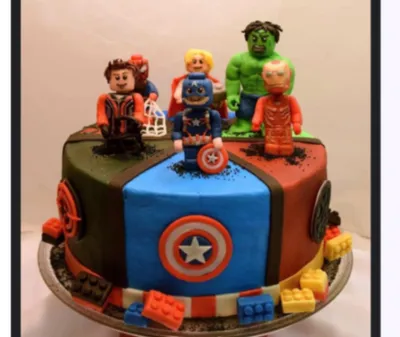 A multicolored 1 Tier Fondant cake themed around Avengers Lego, featuring superhero figures and Lego bricks. A multicolored 1 Tier Fondant cake themed around Avengers Lego, featuring superhero figures and Lego bricks.