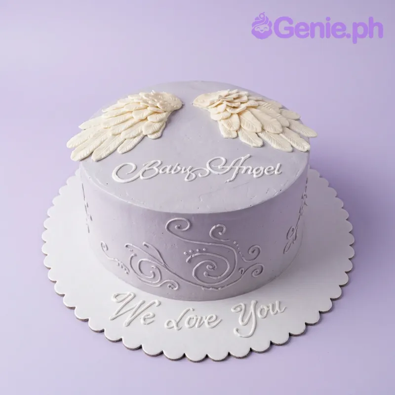 Minimalist gray 1-tier cake with white gumpaste angel wings and piped icing swirls on the side. Minimalist gray 1-tier cake with white gumpaste angel wings and piped icing swirls on the side.