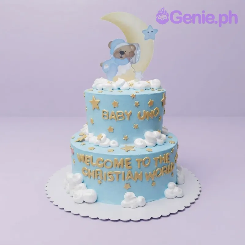 Light blue 2-tier cake with soft icing, a sleeping teddy bear printout on the moon, and gold stars Light blue 2-tier cake with soft icing, a sleeping teddy bear printout on the moon, and gold stars