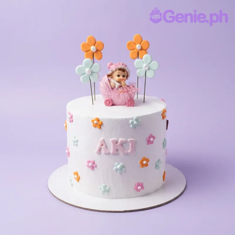 White 1-tier baby girl birthday cake with a pink baby figurine in a stroller and colorful fondant flowers. White 1-tier baby girl birthday cake with a pink baby figurine in a stroller and colorful fondant flowers.