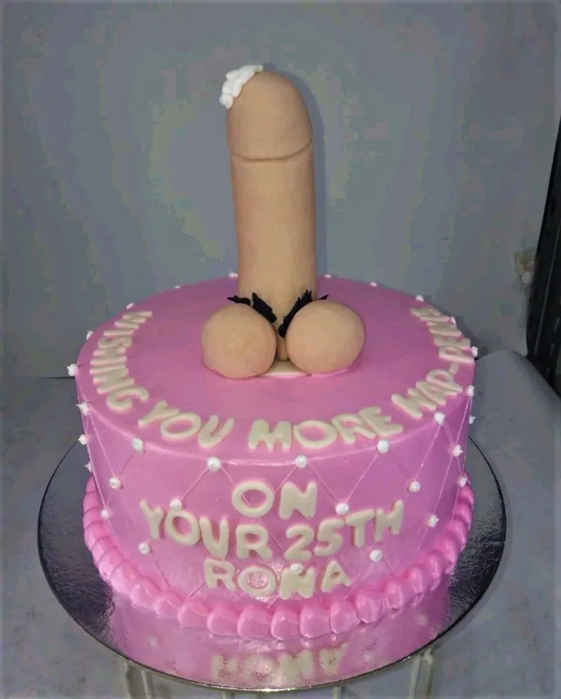 A pink 1-tier Bachelorette cake with a large flesh-colored phallic topper, white icing message, and pink piped border. A pink 1-tier Bachelorette cake with a large flesh-colored phallic topper, white icing message, and pink piped border.