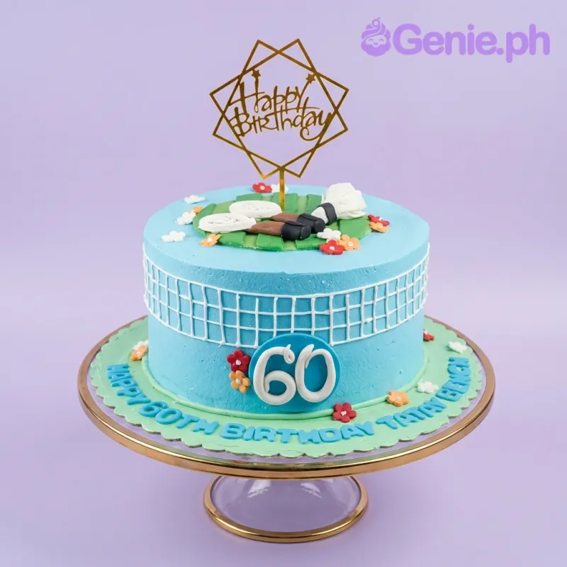 A blue and green 1 Tier Badminton themed cake, with a gold 'Happy Birthday' topper, fondant rackets, and a shuttlecock. A blue and green 1 Tier Badminton themed cake, with a gold 'Happy Birthday' topper, fondant rackets, and a shuttlecock.