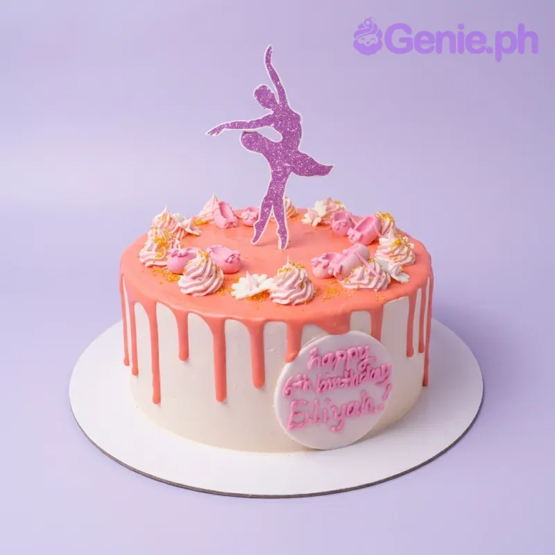 A pink and purple 1-tier Ballerina cake, featuring a glitter ballerina topper, pink icing drips, rosettes, and ballet shoes. A pink and purple 1-tier Ballerina cake, featuring a glitter ballerina topper, pink icing drips, rosettes, and ballet shoes.
