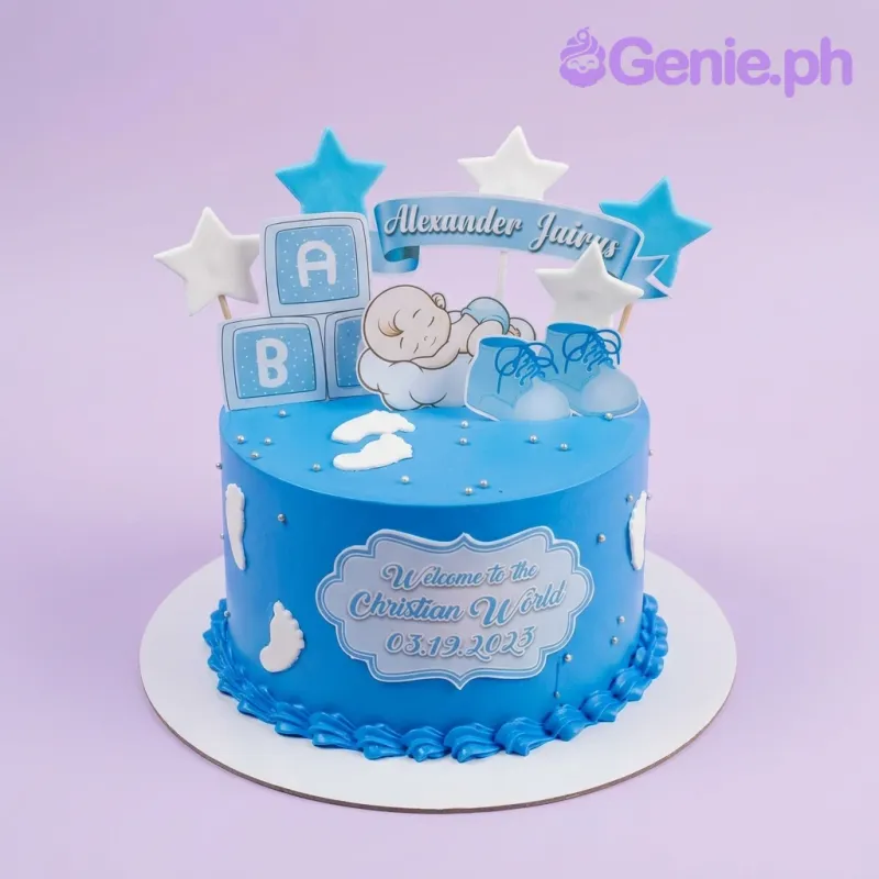 A blue 1-tier Baptism cake featuring a sleeping baby, blue baby shoes, ABC blocks, name banner, and blue and white star toppers. A blue 1-tier Baptism cake featuring a sleeping baby, blue baby shoes, ABC blocks, name banner, and blue and white star toppers.