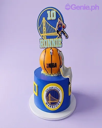 A blue Golden State Warriors 1 Tier basketball cake, with a 3D basketball topper and Stephen Curry printouts. A blue Golden State Warriors 1 Tier basketball cake, with a 3D basketball topper and Stephen Curry printouts.