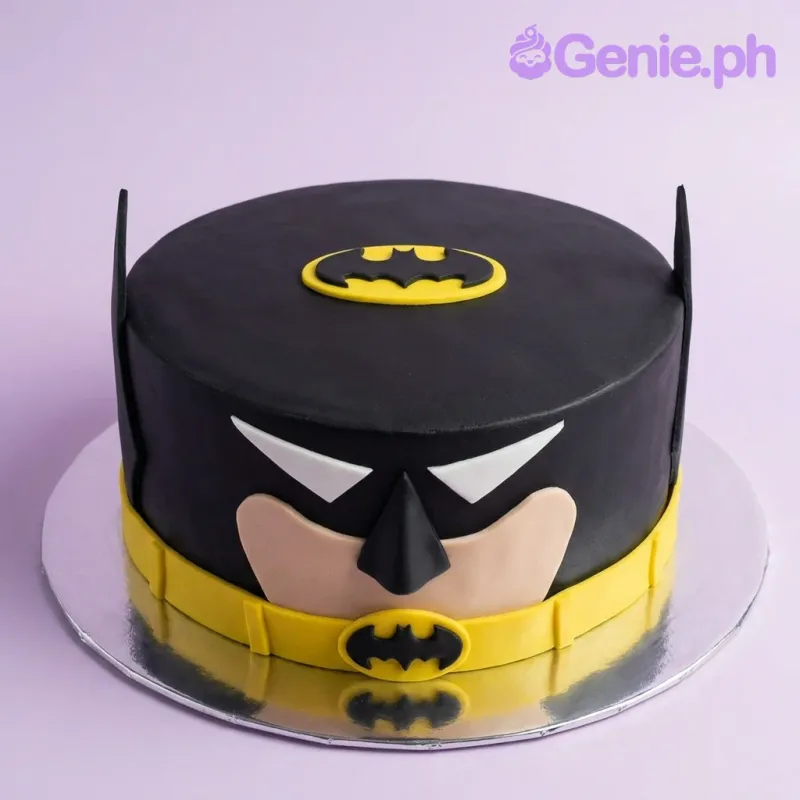 Batman themed black fondant cake with yellow utility belt and bat logo on top. Batman themed black fondant cake with yellow utility belt and bat logo on top.