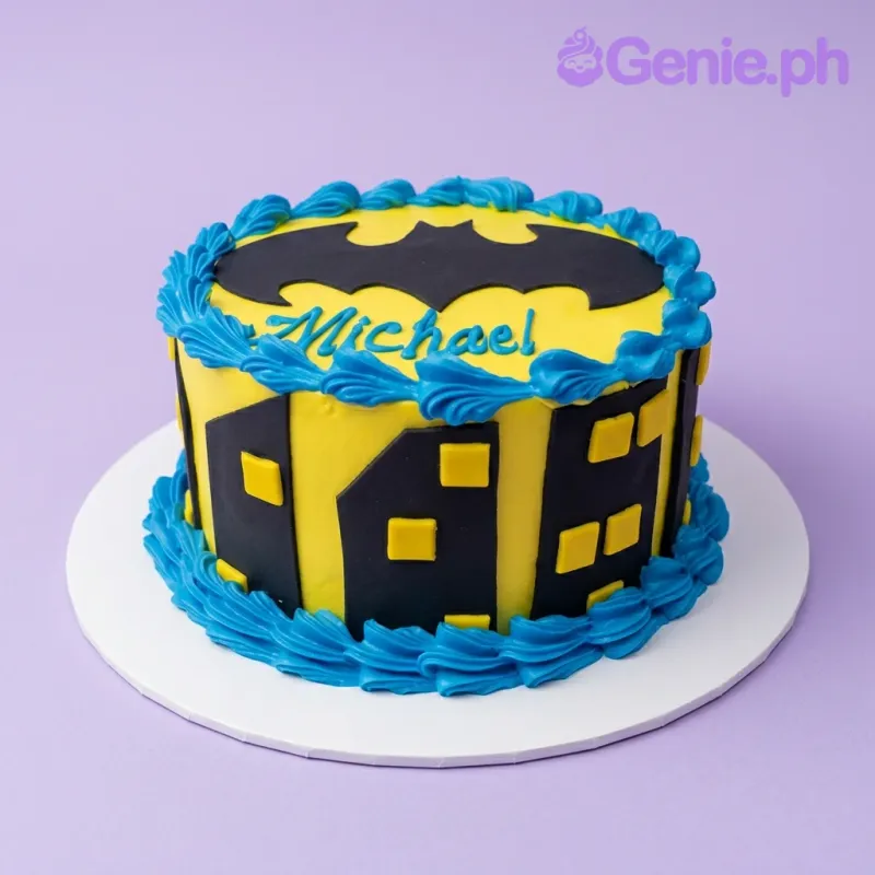Batman themed yellow cake with black city skyline silhouettes and blue icing borders Batman themed yellow cake with black city skyline silhouettes and blue icing borders